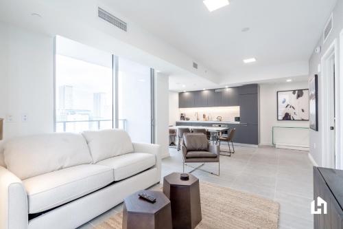 a living room with a white couch and a table at Downtown Miami Condos by Lua Host in Miami