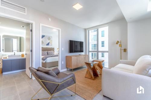 a living room with a couch a chair and a bed at Downtown Miami Condos by Lua Host in Miami