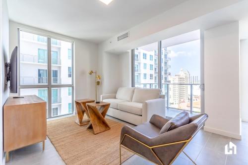 a living room with a couch and a tv at Downtown Miami Condos by Lua Host in Miami
