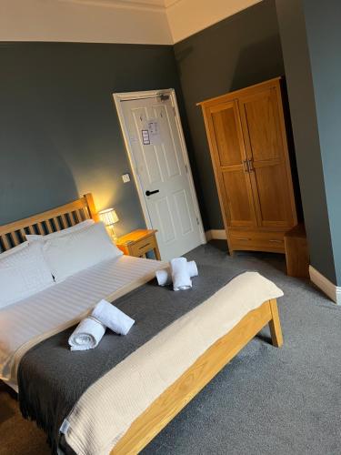 a bedroom with a bed with towels on it at Ambleside Central in Ambleside