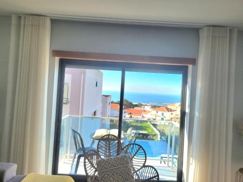 a sliding glass door with a view of a balcony at Panoramic Villa Mar in Nazaré