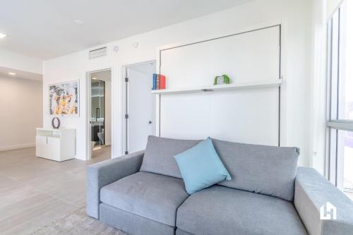 a living room with a couch and a large window at Downtown Miami Condos by Lua Host in Miami
