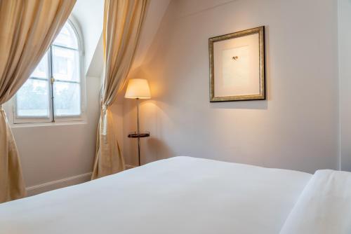 a bedroom with a white bed and a window at Palacio Duhau - Park Hyatt Buenos Aires in Buenos Aires
