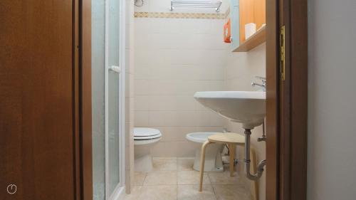 a small bathroom with a sink and a toilet at Italianway - Piazza Campidoglio 3 in Lenno