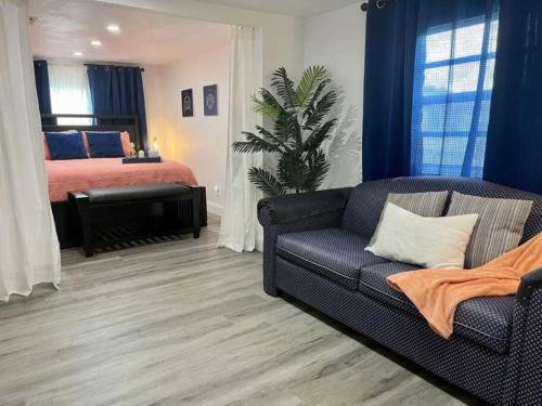 a living room with a bed and a couch at Close to Disney and the Beaches Full House 3/3 in Orlando