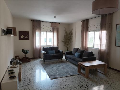 a living room with two couches and a coffee table at Dona Branca in Quiroga