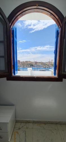 a window in a room with a view of the water at La Terrace in Aswan