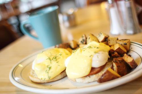a plate of food with eggs and potatoes on a table at McKinley Creekside Cabins in McKinley Park