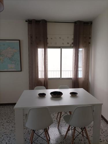 a white table and chairs in a room with a window at Dona Branca in Quiroga