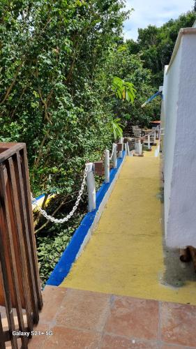 a walkway with blue and yellow paint on it at Top de Buzios Boutique Hotel & Spa in Búzios