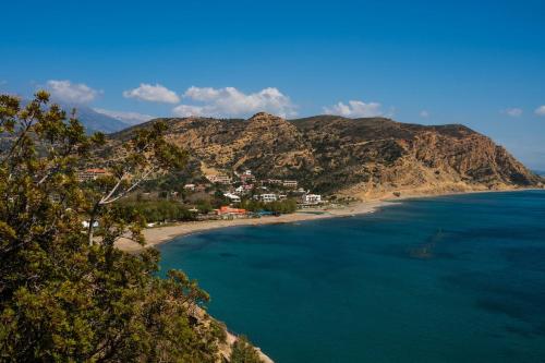 a view of a beach with a mountain at Minos Boutique Hotel in Agia Galini