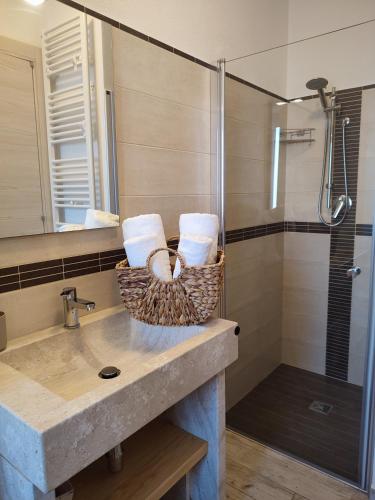 a bathroom with a sink and a shower at B&B Fradama' Holiday in Dorgali