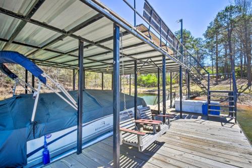 a boat with a canopy on a wooden deck at Georgia Getaway with 2-Story Dock By Lake Hartwell in Hartwell