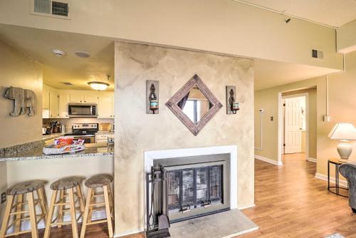 a fireplace in a living room with bar stools at 3 Mi to Sugar Mtn Resort! Family Escape with Balcony in Sugar Mountain