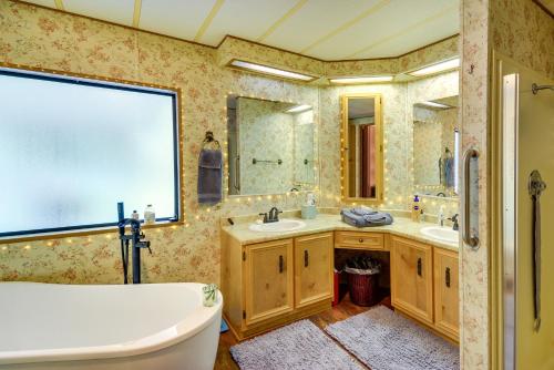 a bathroom with two sinks and a tub and a toilet at Secluded Port Townsend Retreat Pets Welcome! in Port Townsend