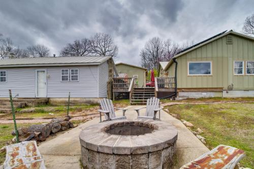 two chairs sitting on a stump in front of a house at Mountain Home Cabin with Fire Pit Less Than 1 Mi to Lake! in Mountain Home