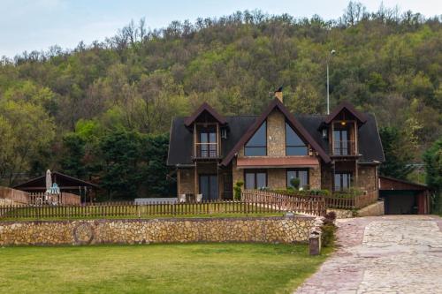 a house on a hill with a stone wall at Villa Tuman Loutra Pozar Aridaias in Aridaia