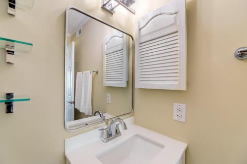 a bathroom with a sink and a mirror at Emerald Isle Vacation Rental with Resort Pool! in Emerald Isle