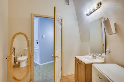 a bathroom with a sink and a toilet and a mirror at Remote Angie Vacation Rental Near Pearl River! 