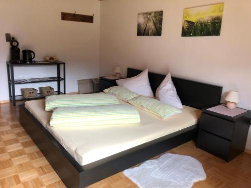 a bed with white sheets and pillows in a room at Egglmeiers Doppelzimmer in Grundlsee