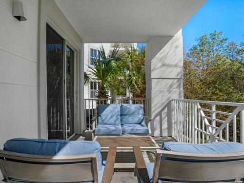 a patio with two chairs and a table on a balcony at Blue Mountain Beach Condominium 102 by Newman-Dailey in Santa Rosa Beach