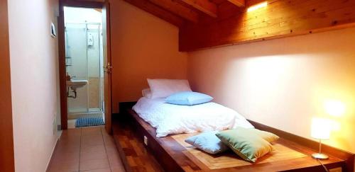 a bedroom with a bed with two pillows on it at Gli appartamenti del Casino dei Civili in Trecastagni