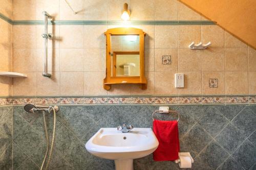 a bathroom with a sink and a mirror at Ta Debora 3 bedroom Villa with private pool in Xagħra