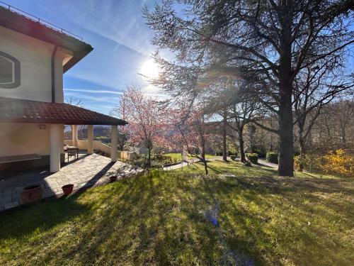 a view of a yard next to a house at PRIVATE VILLA - TENNISCOURT in the moutains 19 GUESTS Cairo Montenotte VILLAITALY EU in Cairo Montenotte