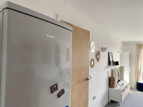 a door in a room with a white wall at Cosy Egyptian Inspired Apartment Northampton in Northampton