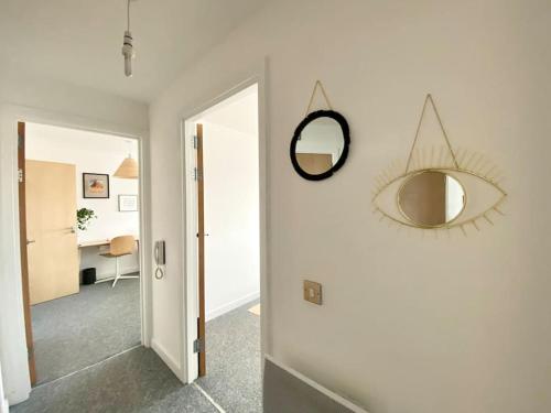 a hallway with a mirror on a wall at Cosy Egyptian Inspired Apartment Northampton in Northampton