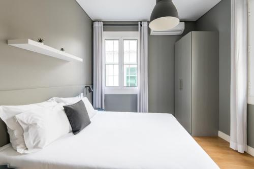 a bedroom with a white bed and a window at Amazing Old Town - Apartments by SBH in Funchal