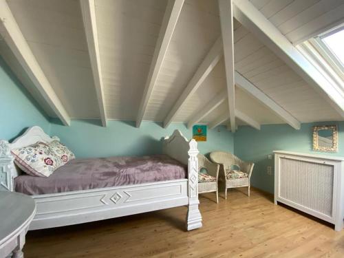 a bedroom with a bed with purple sheets and blue walls at Villa-Agave , by the sea in Porto-Rafti outside Athens in Porto Rafti