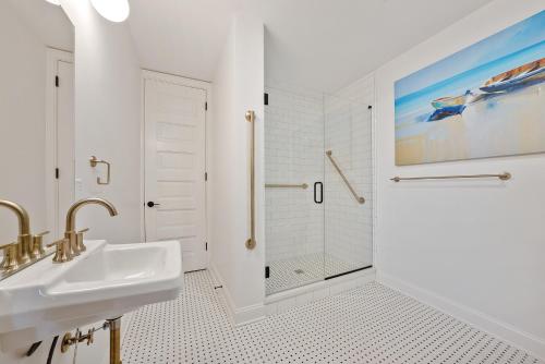 a white bathroom with a sink and a shower at Beautiful Condo 2 Bedroom Condo Close to Battery Park Marina - C D in Sandusky