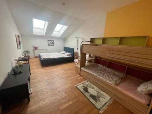 a room with two bunk beds and a couch at Apartmán Lidická in Karlovy Vary