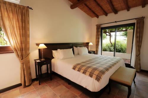 a bedroom with a bed and a large window at Casa Agostino - Luxury wine resort in Mendoza