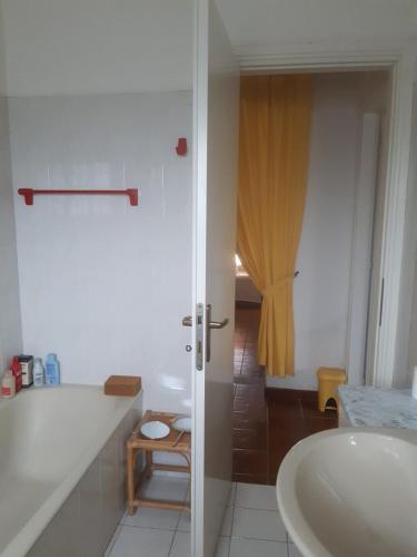 a bathroom with a white tub and a sink at la casa di Mario in Itri
