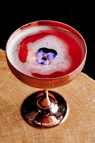 a bowl with a purple flower on top of it at Mauna Kea Beach Hotel, Autograph Collection in Hapuna Beach