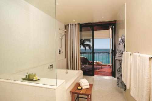 a bathroom with a tub and a view of the ocean at Mauna Kea Beach Hotel, Autograph Collection in Hapuna Beach