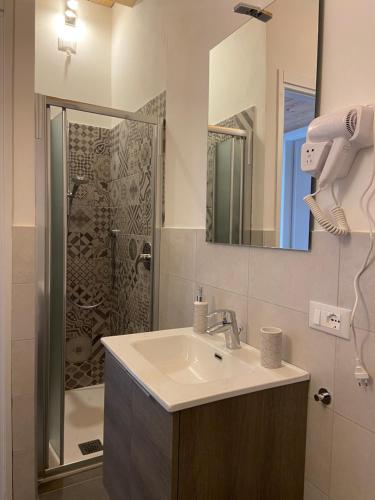 a bathroom with a sink and a shower at Little Sweet House in Cantù