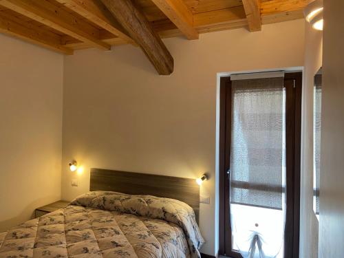 a bedroom with a bed and a window at Little Sweet House in Cantù