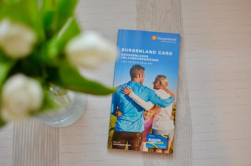 a book on a wall with a picture of a couple at Privatzimmer Haider in Illmitz