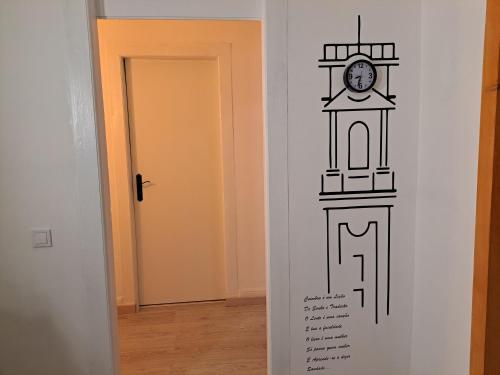 a clock on a wall next to a door at Guest dAires in Coimbra