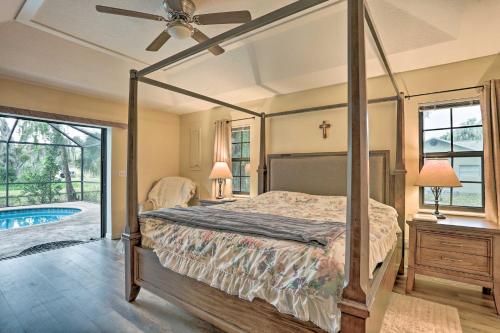 a bedroom with a canopy bed and a pool at Stuart Vacation Rental Walk to Private Boat Dock! in Stuart