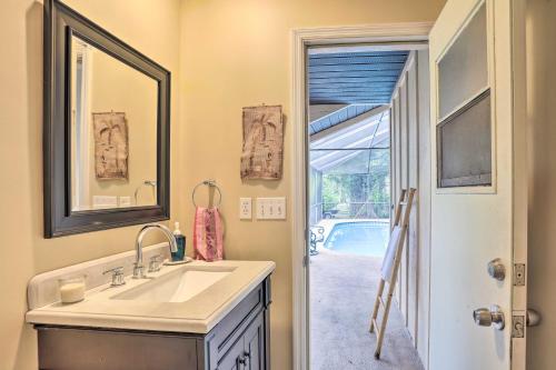 a bathroom with a sink and a mirror at Stuart Vacation Rental Walk to Private Boat Dock! in Stuart