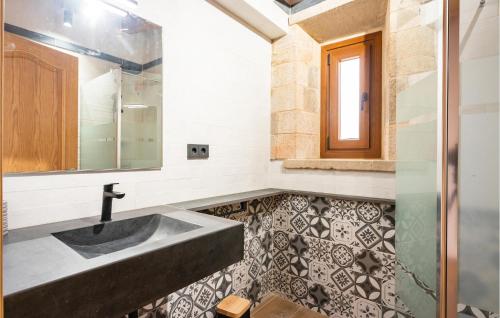 a bathroom with a sink and a mirror at Lovely Home In Vilademuls With Swimming Pool in Vilademuls
