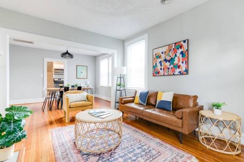 a living room with a couch and a table at Private Boho Bungalow 10 Minutes to Downtown RVA! in Richmond