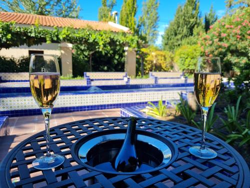 two glasses of wine are sitting on a table at Casa Agostino - Luxury wine resort in Mendoza