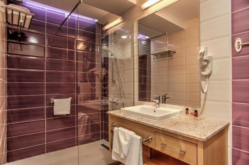 a bathroom with a sink and a shower at Holiday Inn Plovdiv by IHG in Plovdiv