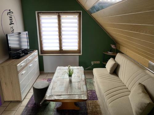 a living room with a couch and a table at Ferienwohnung/Monteurwohnung SZ-Reiki in Erbendorf