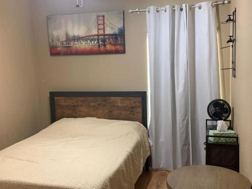 a bedroom with a bed with white curtains and a table at Lake Shores Suites in Shady Shores
